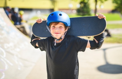 A,nice,boy,with,skateboards,outside,on,skate,playground